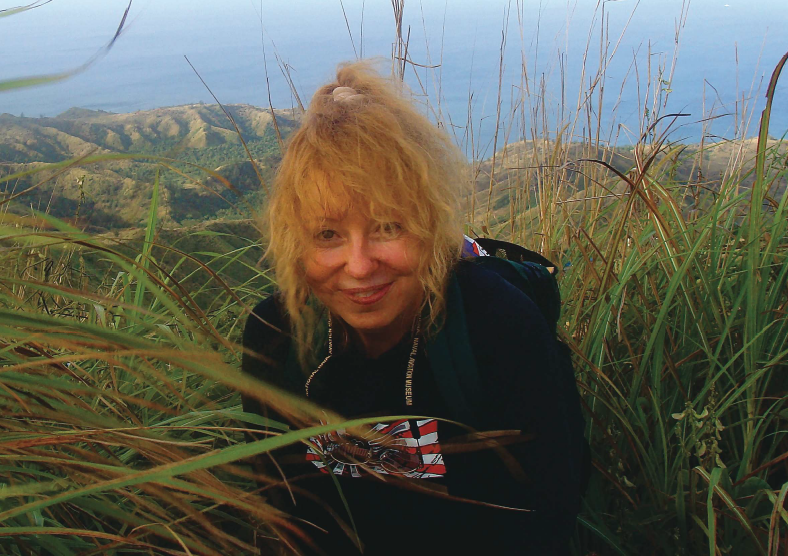 Kathy Fedack, M.D., on the summit of Mt. Lamlam in Guam. The base of Mt. Lamlam rises from the bottom of the Mariana Trench—making it one of Earth's highest mountains.