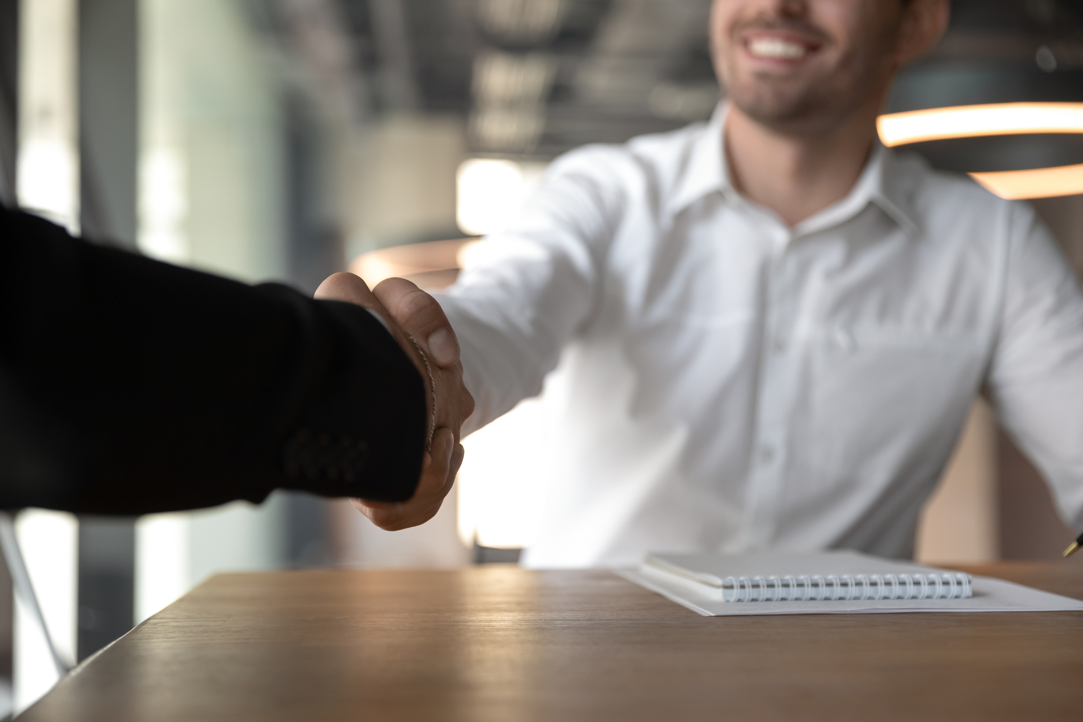 Business people handshaking, making deal, partnership agreement close up