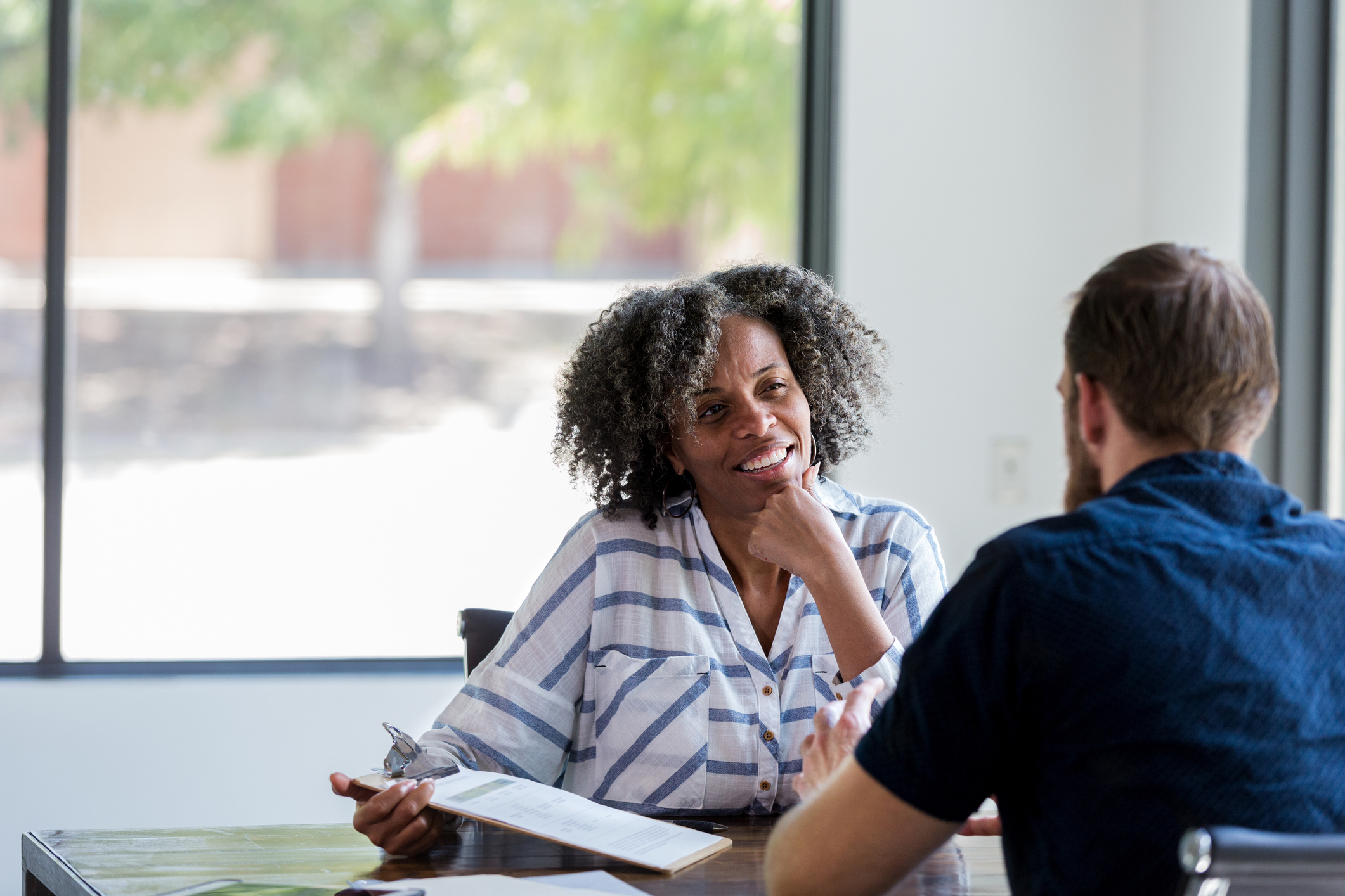 Mature businesswoman talks withe male colleague