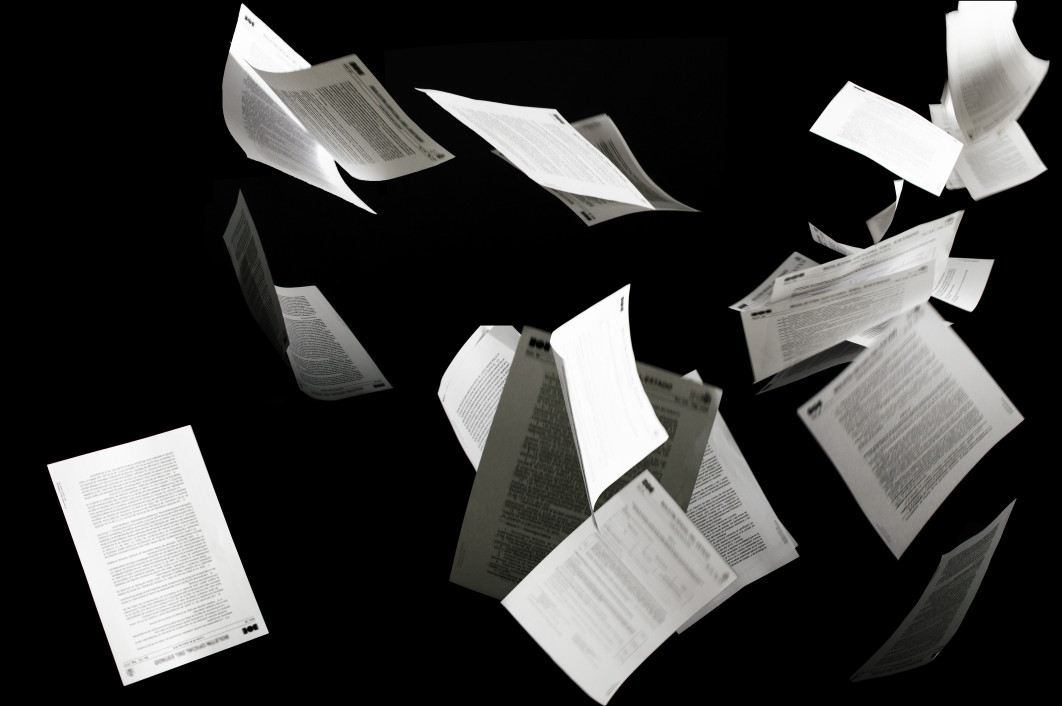 Many flying business documents isolated on black background Papers flying in air in business concept