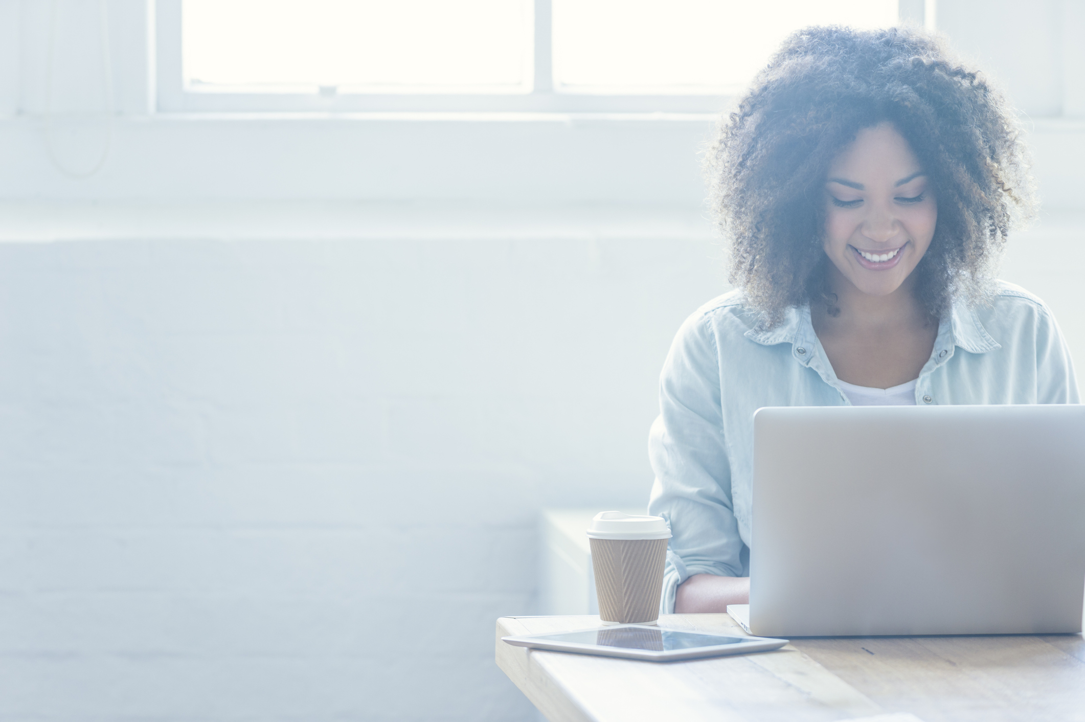Woman working on a laptop.