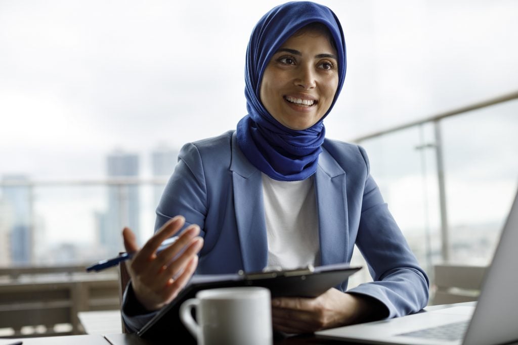 female employee speaking in a meeting