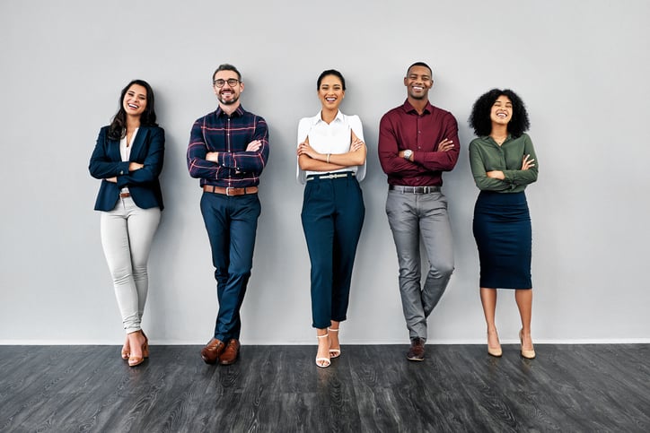 Five people standing in a line appearing relaxed and confident