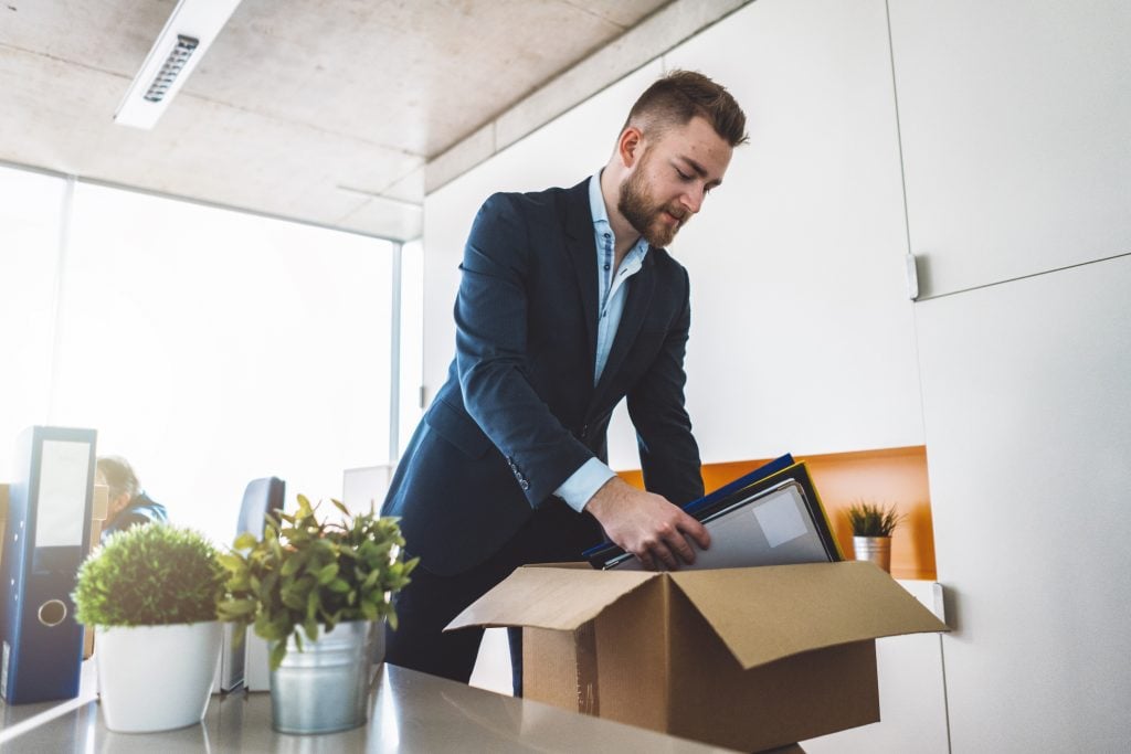 Businessman unpacking boxes