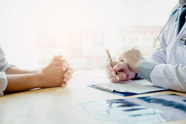 Doctors and patients sit and talk. At the table near the window in the hospital. Doctors and patients sit and talk. At the table near the window in the hospital.